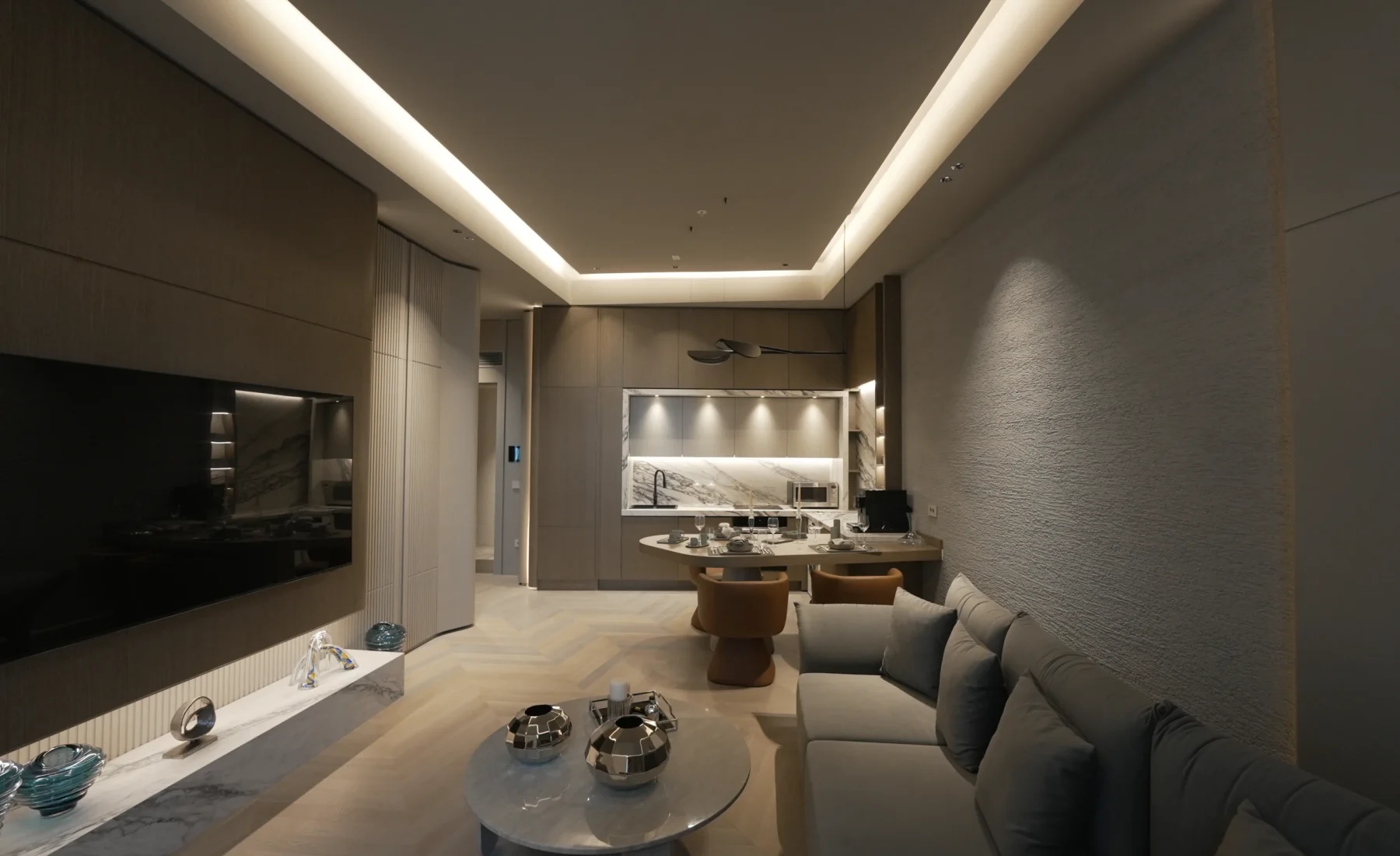 Open-plan living and kitchen interior in the 1+1 show residence